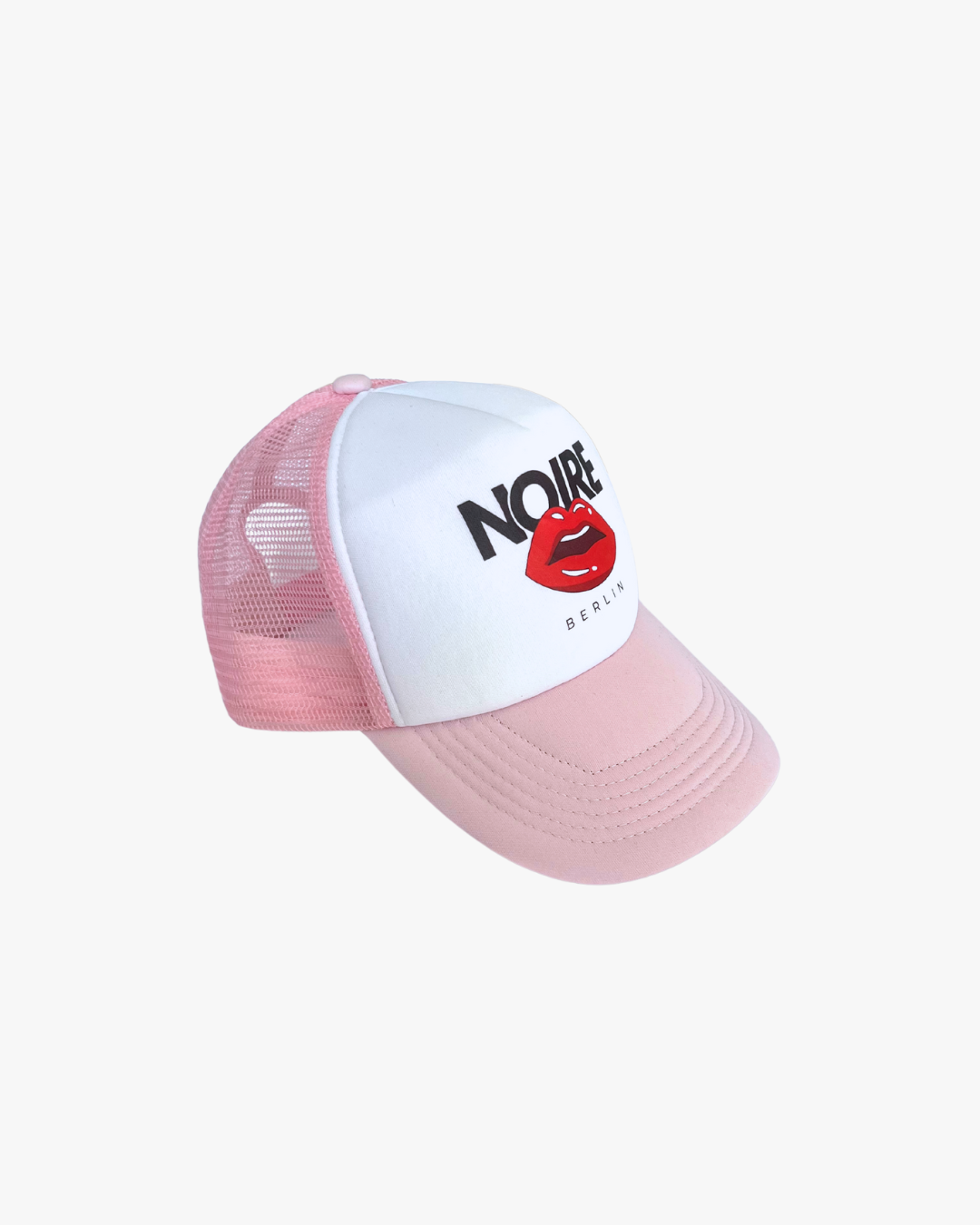 Side view of Noire Berlin/Noire Clothing Candy Pink Trucker Cap featuring red lips logo and white front panel.